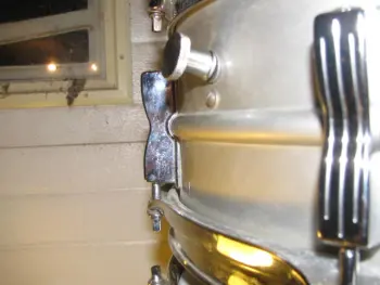 Ludwig Muffler screw under the knob or over the knob???