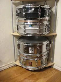 Here is a great inexpensive shelf for snare display $39.00