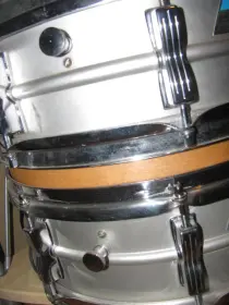 Ludwig Muffler screw under the knob or over the knob???